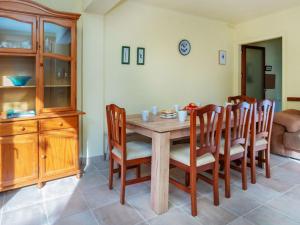 a dining room with a wooden table and chairs at Holiday Home Can Can Grau by Interhome in Platja  d'Aro