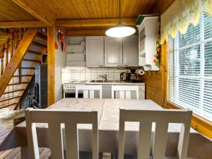 a kitchen with a table and chairs in a room at Holiday Home Missi by Interhome 