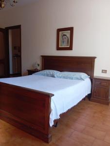 a bedroom with a bed with a wooden frame at Lake & bike Mergozzo in Mergozzo +9 photos