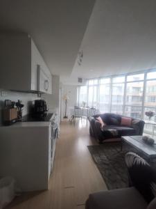 a kitchen and a living room with a couch and a table at Downtown Toronto Condo Suite in Toronto