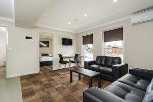 a living room with a couch and a table at Parkville Place Serviced Apartments in Melbourne