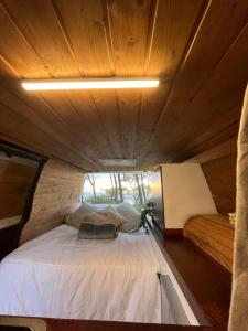 a small room with a bed in a tiny house at Van Camper Ibiza Volkswagen T4 Van Voyage in Ibiza Town