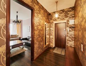 a hallway with a living room with wallpaper at River view Cathedral Apartment in Vilnius