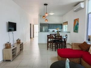 a living room with a couch and a dining room at Rooming House in Playa Blanca
