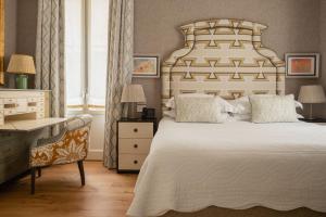 a bedroom with a large bed and a desk and a chair at Vmaison Brera Milano in Milan