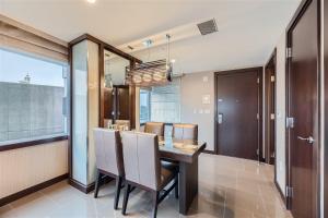 a dining room with a table and some chairs at Corner Suite at Vdara Hotel and Spa in Las Vegas