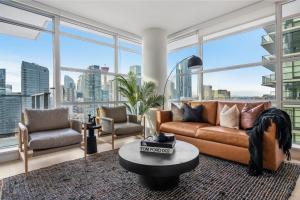 a living room with a couch and chairs and windows at Manhattan in Calgary