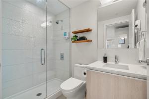 a bathroom with a toilet and a sink and a shower at Manhattan in Calgary