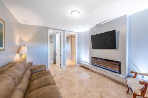 a living room with a couch and a fireplace at Sailmakers Place 703 in Perdido Key