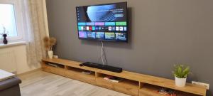a living room with a flat screen tv on a wall at Ferienwohnung ASL in Aschersleben