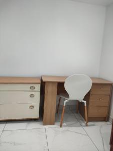 a desk with a white chair next to a drawer at House of Peace in Oxford