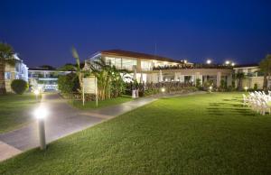 a house with a lawn in front of it at night at Sun Club Side Hotel - All inclusive in Side
