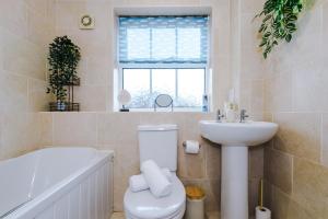 a bathroom with a toilet and a sink and a tub at NEW! Incredible Home In Northwich By 53 Degrees Property, Perfect For Groups, FREE Parking! in Northwich