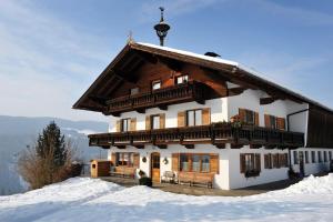 a house on top of a snow covered mountain at Gugghof in Hopfgarten im Brixental