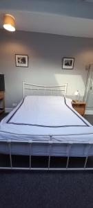 a bed in a room with a white mattress at Serene Homes Sheffield, Private Ensuite Velux Room in Hillsborough