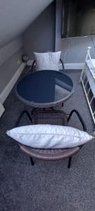 a table in a room with a pillow on a chair at Serene Homes Sheffield, Private Ensuite Velux Room in Hillsborough