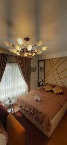 a bedroom with a large bed and a ceiling fan at Studio-Type Condotel Mesatierra Garden Residences in Davao City