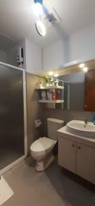 a bathroom with a toilet and a sink at Studio-Type Condotel Mesatierra Garden Residences in Davao City