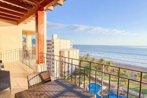 a balcony with a view of the ocean at Seaview Oasis 1-BR Suite in Croc's casino resort in Jacó