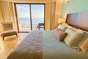 a bedroom with a bed with a view of the ocean at Seaview Oasis 1-BR Suite in Croc's casino resort in Jacó +41 photos