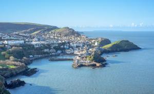 an aerial view of a town in a body of water at 56 Meadow View in Woolacombe
