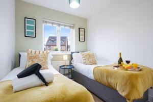 a bedroom with two beds and a window at Forthill House - Close to City Centre - Free Parking, Super-Fast Wifi and Smart TV with Netflix by Yoko Property in Milton Keynes