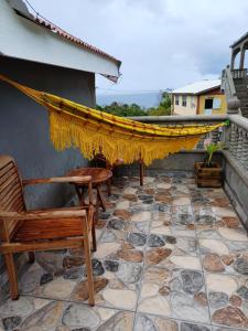 a patio with a hammock on top of a house at Cottage Haven Escape in Portsmouth