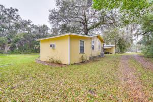 a small yellow house in the middle of a field at Quiet Retreat with Boat Parking, 2 Mi to Marina in Inglis