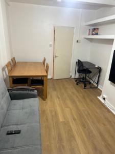a living room with a table and a couch at one bedroom apartment in Tower Bridge road in London