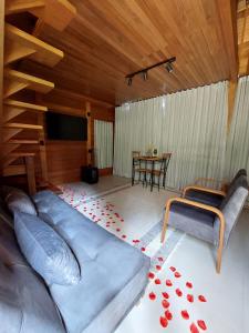 a living room with a large blue couch and a table at Villa di Madeira in Divisa