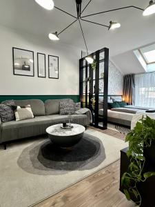 a living room with a couch and a table at D26 Luxury Suites in Budapest