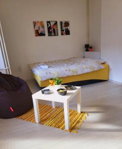 a room with a bed and a table with a table sidx sidx sidx at City Center White Apartment! in Skopje