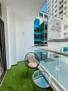 a balcony with a chair and a table at Cozy 1 Bedroom in the heart of Dubai Marina in Dubai