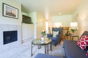 a living room with a couch a table and a fireplace at Napa Valley Golf View Condo in Silverado in Napa