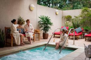 two women sitting next to a swimming pool at Napa Valley Golf View Condo in Silverado in Napa