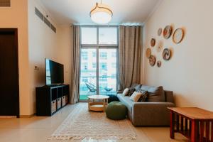 a living room with a couch and a large window at Cozy 1 Bedroom in the heart of Dubai Marina in Dubai