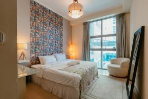 a hotel room with a bed and a window at Cozy 1 Bedroom in the heart of Dubai Marina in Dubai