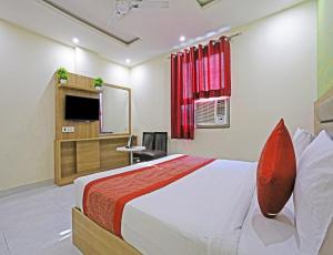 a bedroom with a bed and a flat screen tv at Hotel MANUAL GRAND Near International Airport BY-Gross Group in New Delhi