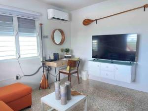 a living room with a large flat screen tv at Nela’s Beach House in Arecibo