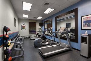 a gym with several treadmills and elliptical machines at Hampton Inn Belmont at Montcross in Belmont