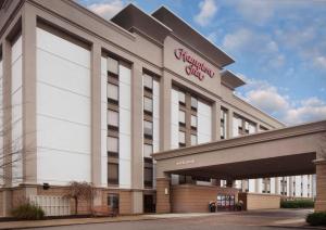 a large white building with a sign on it at Hampton Inn Charleston-Southridge in Charleston
