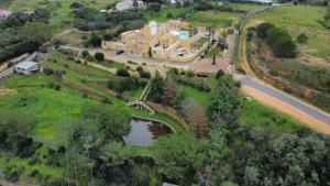 an aerial view of a large house with a pond at Quinta Nova Vale Del Rey in Carvoeiro