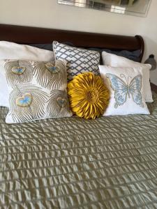 a bed with pillows and a flower and a butterfly at The Barracks House of Joy in New Orleans