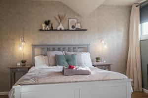 a bedroom with a large white bed with pillows at Vintage 4 Bed Property, - Luxury Roll top Bath in Room in South Shields