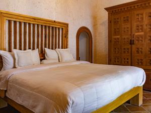 San Salvador el Seco的住宿－Hacienda La Concepción，卧室配有带白色枕头的大床
