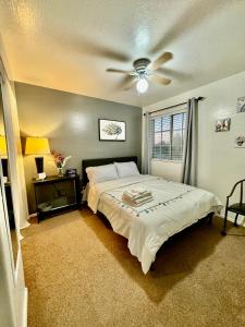 a bedroom with a bed and a ceiling fan at Modern Private room By Cardinals State Farm stadium in Phoenix