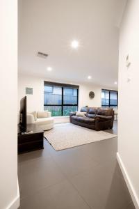 a living room with a couch and a television at Modern Home for Large Groups or Families in Newstead