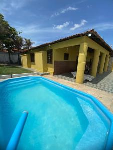 una grande piscina blu di fronte a una casa di Casa Beira Mar - Praia Icaraí - CE a Caucaia