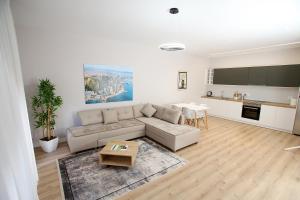 a living room with a couch and a table at The Met Apartments in Durrës