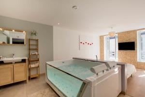 a large aquarium in a bathroom with a sink at Le Pavean in Beaune